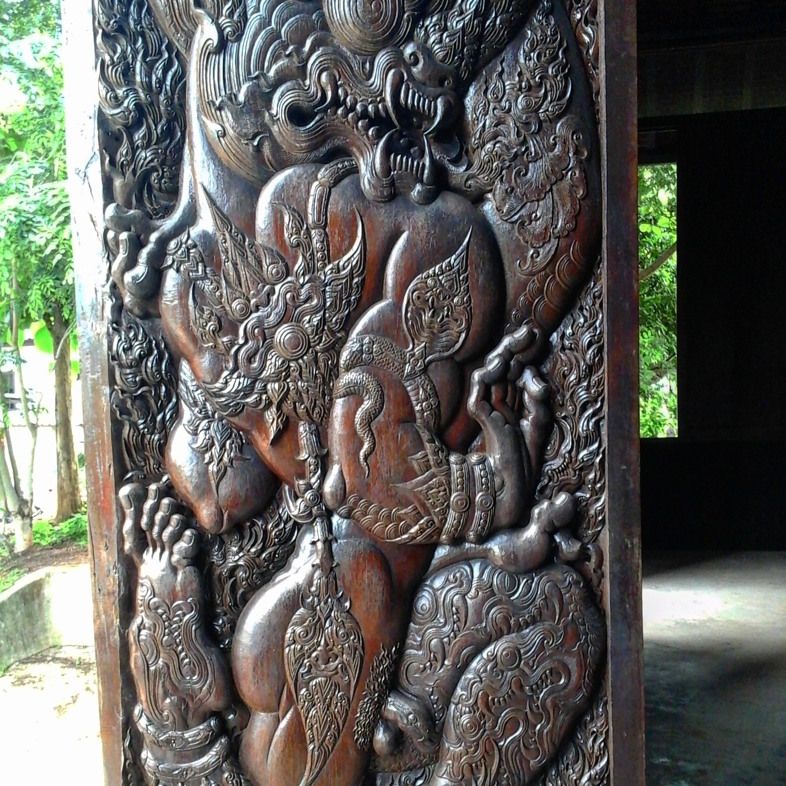 IBeautifully carved wooden door panels in the main building of Baan Daam